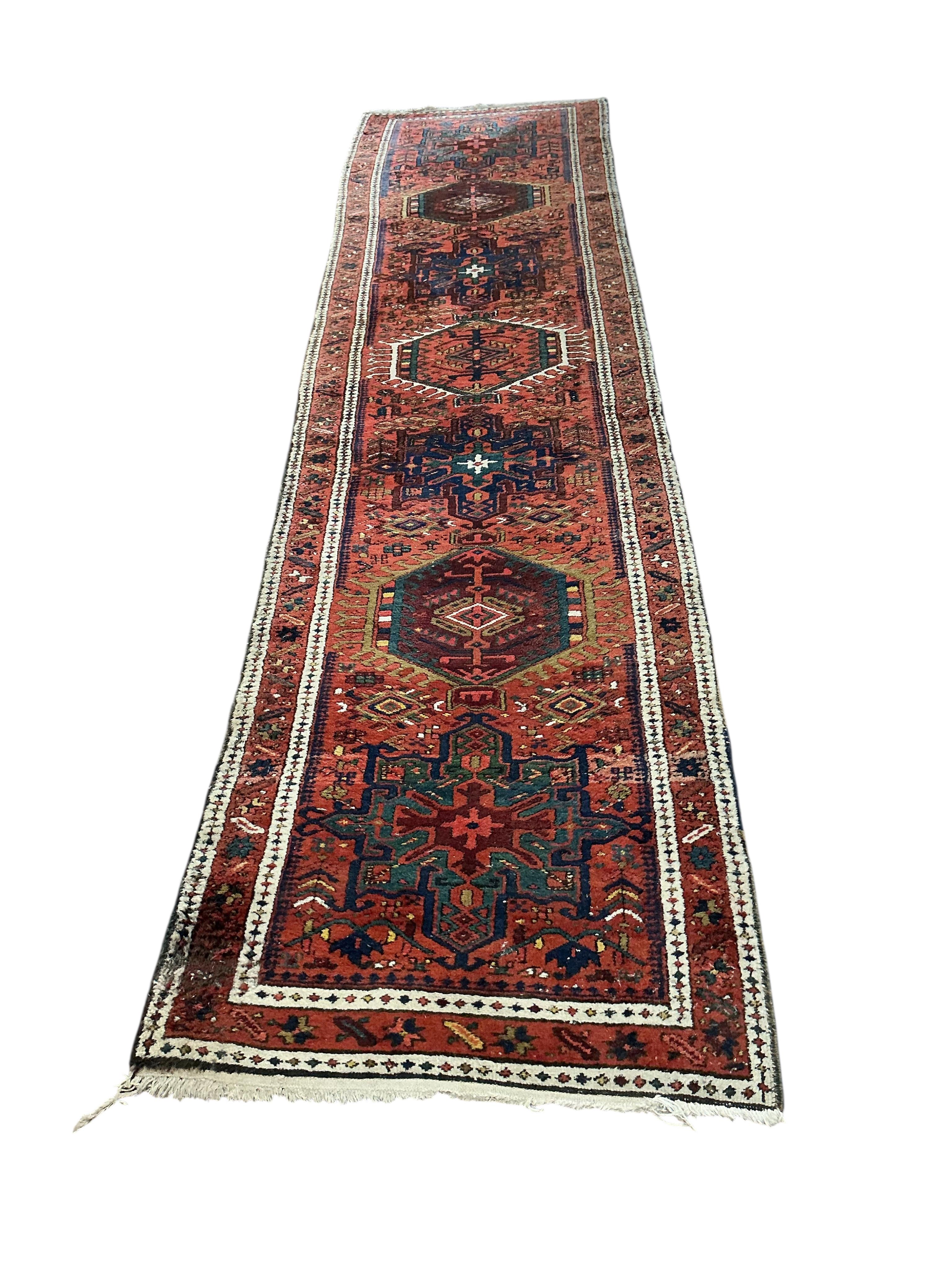 A Karaja runner, the red field with six medallions, 335 x 82cm